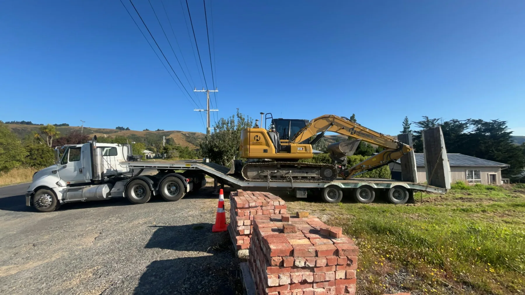 Hosking's truck transporting an excavator